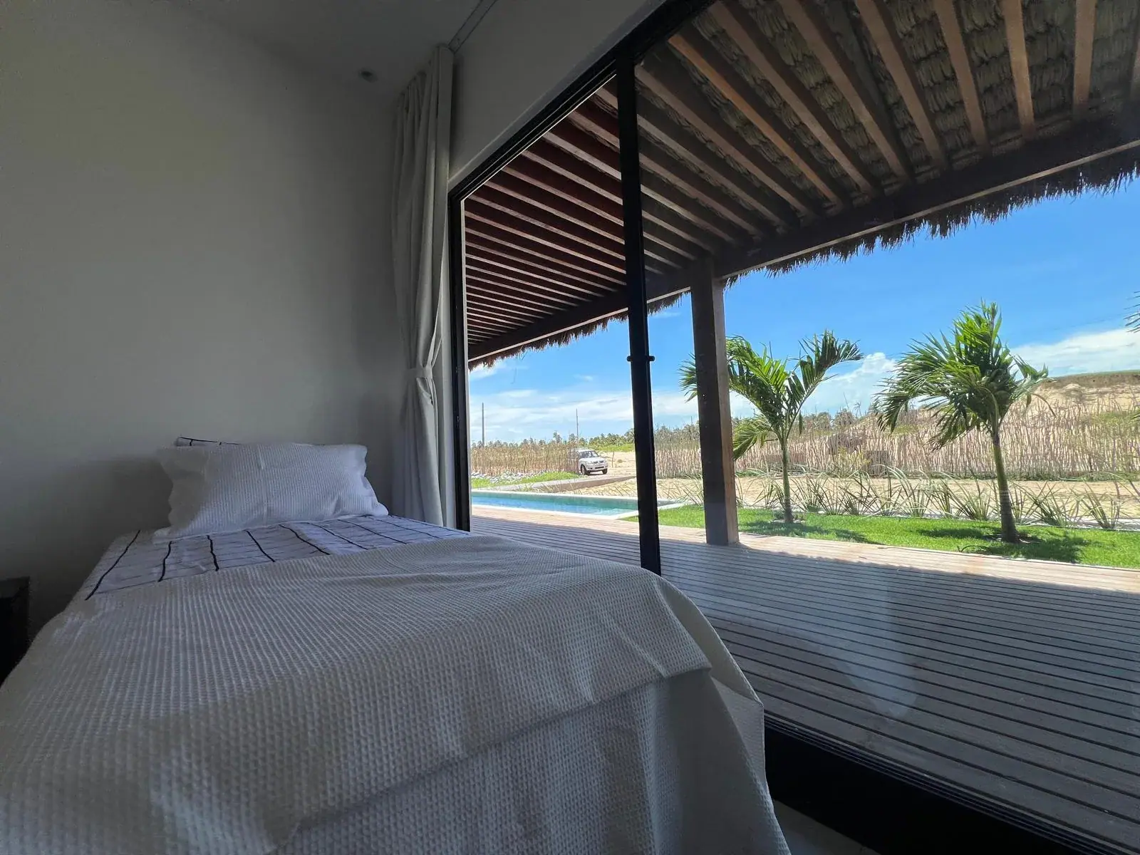 Main bedroom with view of the pool and the deck