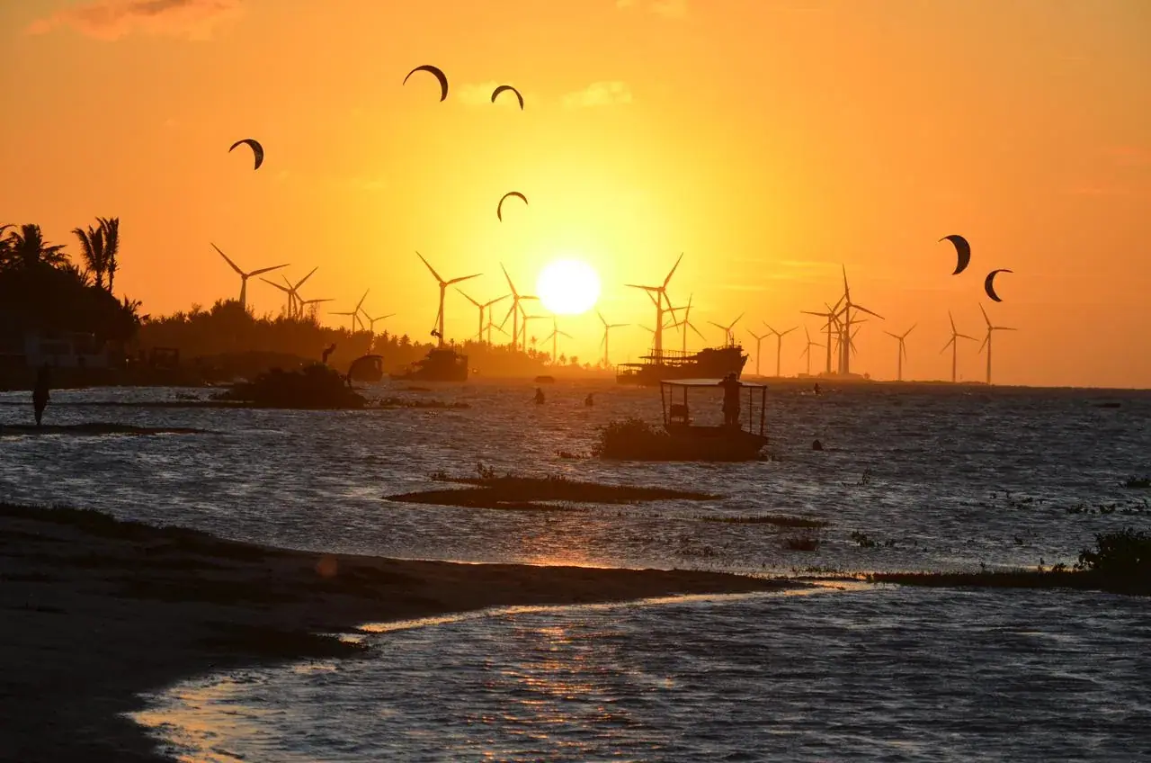 Kites over the lagoon at sunset in Ilha do Guajirú, Ceará