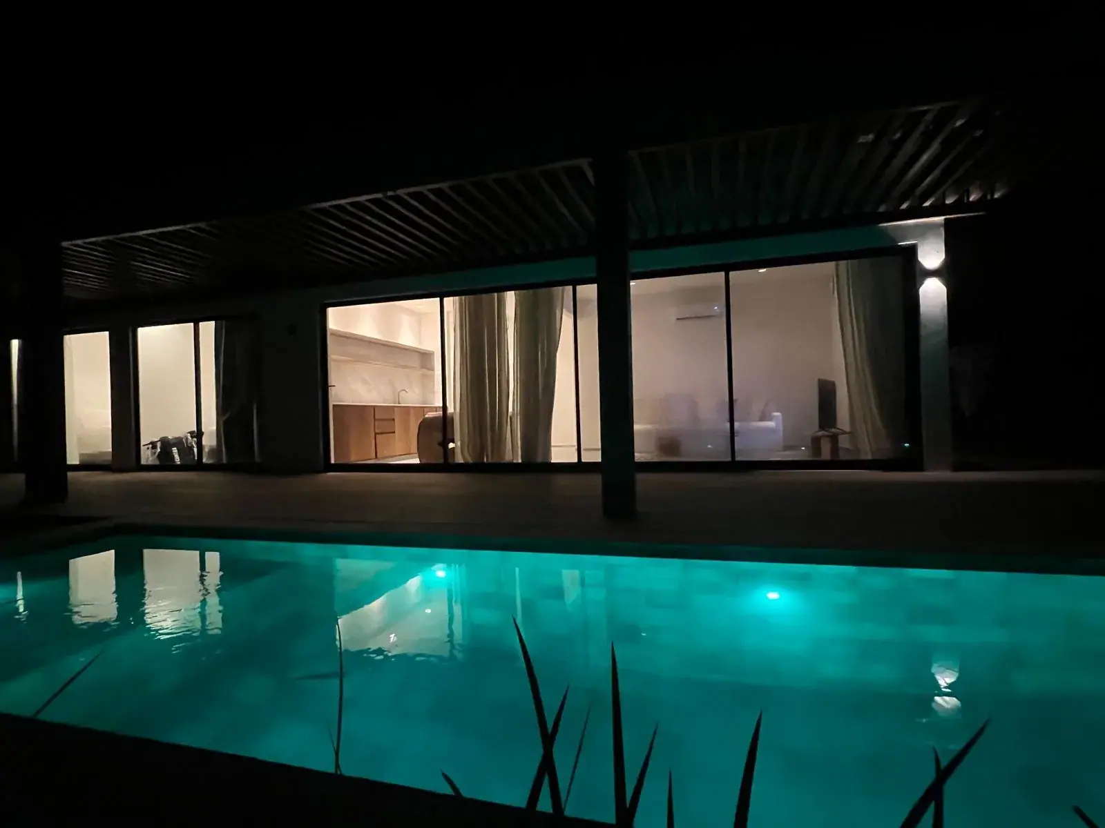 Private pool lit up at night at VENTI Kite Homes